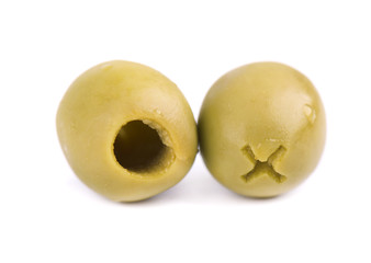 Pitted and marinated green olives in wooden bowl, isolated on white background.