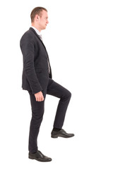 Businessman step up a staircase isolated on white background