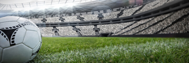 Soccer ball on white marking line against rugby stadium