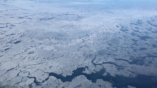 Handheld shot of huge chunks of ice frozen over the Bering Sea in the North Pacific ocean in winter.