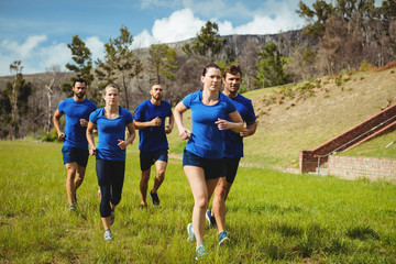 Fit people running in boot camp