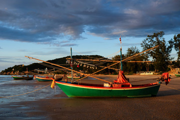 Fototapeta na wymiar Fisherman boat docking on the beach at evening time in Huahin, Thailand