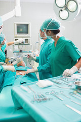 Surgeons checking a monitor while operating