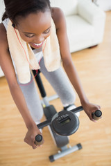 High view of a black woman sitting on an exercise bike