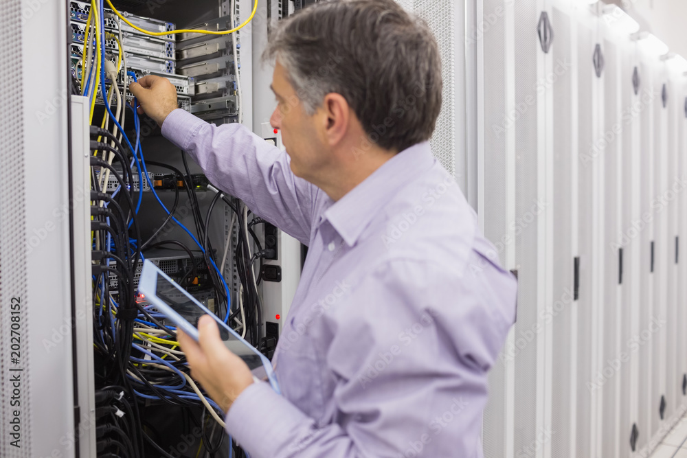 Poster man doing server maintenance with tablet