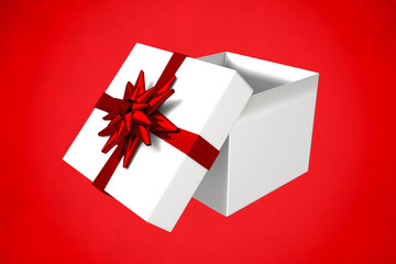 White and red gift box against red background