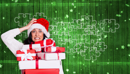 Shocked woman with christmas presents against star pattern on green planks