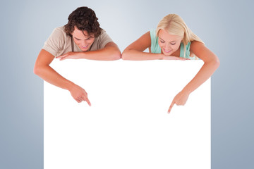 Man and woman pointing on a whiteboard against grey vignette