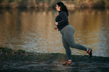 Overweight woman runner go jogging outdoors