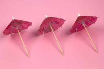top view cocktail umbrellas pattern pink background