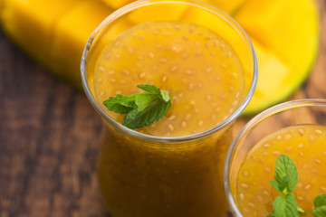Fresh mango smoothie in glass with chia seeds