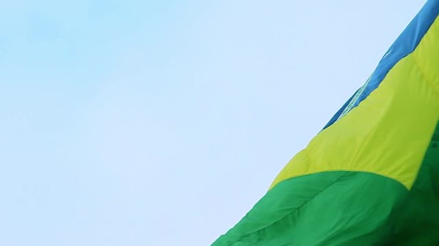 Real Brazil flag waving in the wind in slow motion. The Brazilian flag is a national symbol of this 5-times soccer Worldcup country going through Elections in 2018.