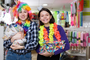 Fototapeta premium Positive female friends with bags of confetti