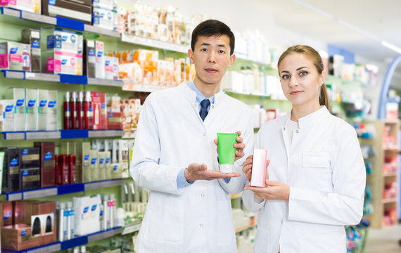 Pharmacists standing with medicine on their work place in apothecary