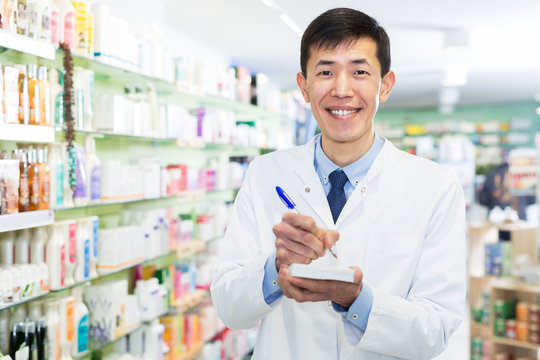  male pharmacist is inventorying medicaments