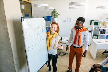 joyful student with red hair is preparing for session with her classmatess in the university. math tutor