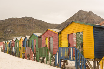 Multi colored wooden beach huts on sand