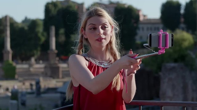 Smiling carefree young tourist taking selfie in Rome- close up