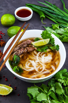 Vietnamese Pho Noodle Soup. Beef with Chilli, Basil, Rice Noodles, Bean Shoots showing noodles