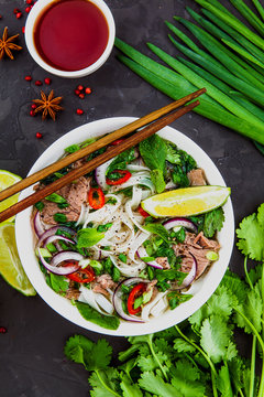 Vietnamese Beef Noodle Soup Pho Bo with beef on dark background