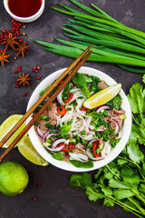 Vietnamese Beef Noodle Soup Pho Bo with beef on dark background - 202722539