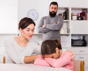 Father lecturing wife and daughter