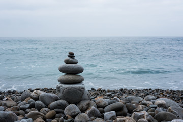 Stack of stones on beach, sea and sky