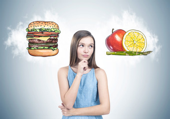 Pensive teen girl in blue dress, food choice