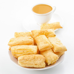 Fototapeta na wymiar Indian Tea Time Breakfast Khari Also Know as Kharee, Khari Biscuit or Salty Puff Pastry Snacks, Served with Indian Hot Masala Chai or Hot Tea Isolated on White Background