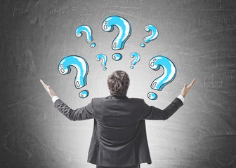 Happy businessman gesturing, looking for answer