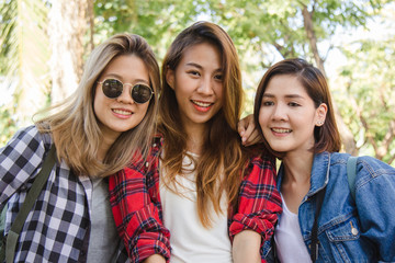 Group of young Asian women sitting along the street enjoying their city lifestyle in a morning of a weekend waiting for out door activity. Young women group and their city lifestyle. lifestyle concept