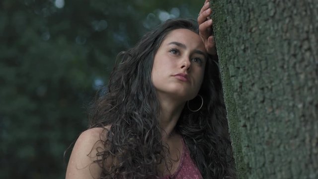 Thoughtful And Sad young Woman Thinking leaning  A Tree- sadness,thoughts