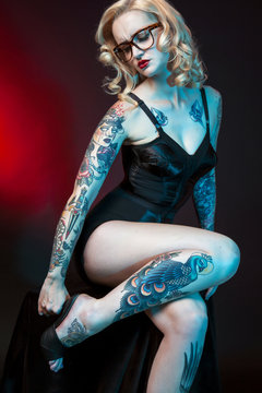 Beautiful girl with tattooed arms.,