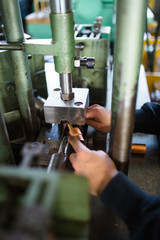 Metallurgy heavy industry. Factory for production metal parts. Close up shot of workers hand.