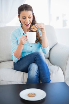 Happy Woman Dunking Biscuit Into Hot Chocolate