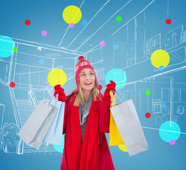 Blonde in winter clothes holding shopping bags against blue vignette