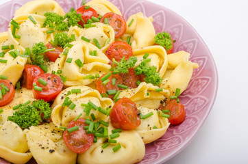 Filled tortellini with herbs, tomatoes