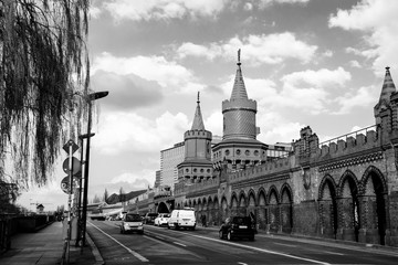 Oberbaum bridge - a double-deck bridge over River Spree in Berlin, Germany with cloudy sky. Black and white