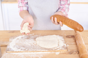 Preparation of test. White flour. Wooden table. Ready made pastry