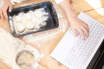 Process of cooking buns. Raw dough. White flour. Bright laptop