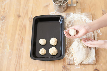 Raw dough. Black pan. Cooking buns. Delicious recipe