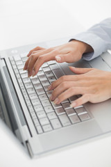 Fototapeta na wymiar Close up of hands typing on laptop keyboard