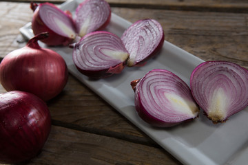 Onions in a tray on a wooden table