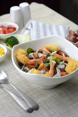 Fresh salad with fried shrimps tempura.
