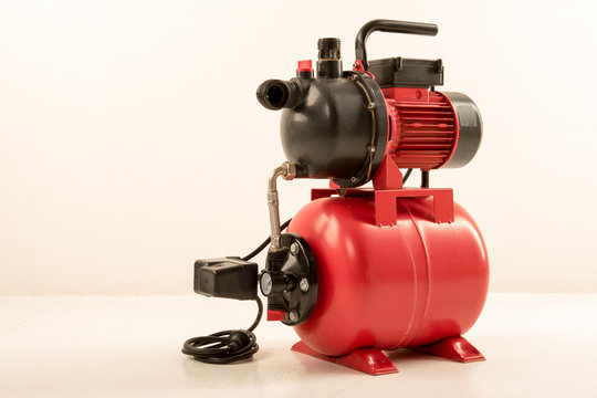 Red surface water pump. White background