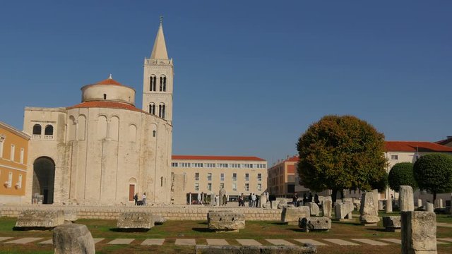 A church and ruins in a sunny square