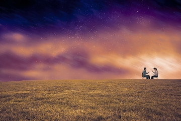 Sitting couple having an argument against aurora night sky in purple