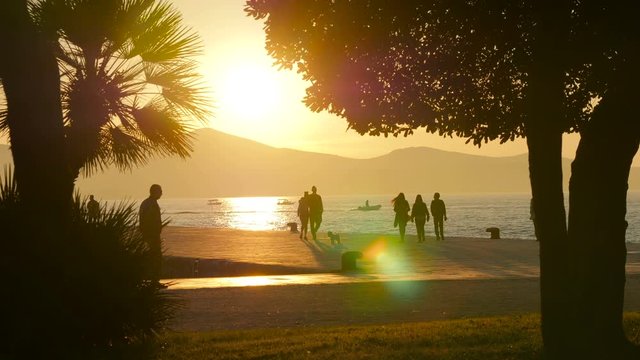 People taking a walk at sunset