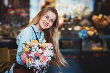 Young florist with a bouquet of flowers