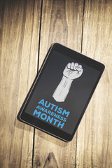 Autism awareness month against overhead of tablet on desk